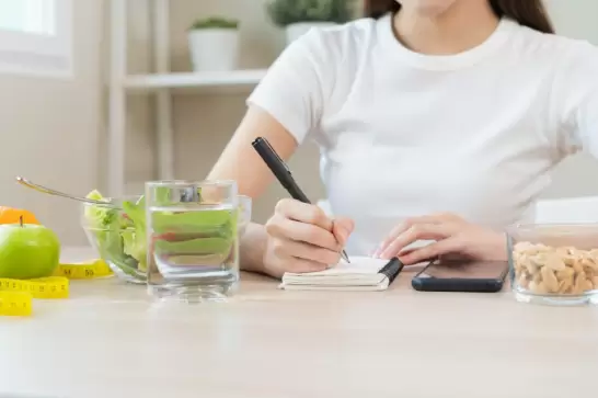 Woman keeping track of what she is eating