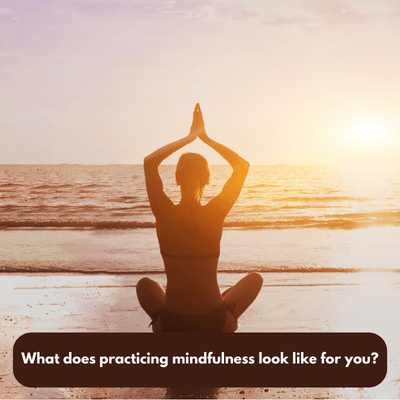 Woman practicing yoga on the beach